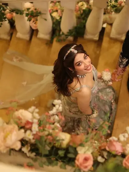 A dreamy, artistic shot of this beautiful look. The floral setting perfectly complements the ethereal vibe of her outfit and makeup.