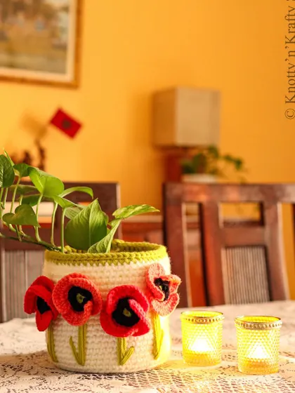 The Poppy Basket styled on a dining table with candles, showing how it can be a beautiful centerpiece for a special meal.