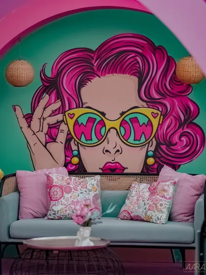 A close-up of the pop-art backdrop from our 'Mehendi Fiesta'. The 'WOW' graphic and floral-adorned hair create a fun, retro-glam photo spot that is full of personality.