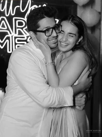 The raw emotion of a post-proposal hug, captured in classic black and white. This image is all about the feeling of overwhelming joy and love.