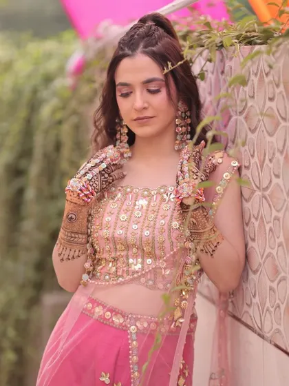 This candid shot shows how the Mehendi makeup looks natural and beautiful in an outdoor setting. The focus is on a fresh, glowing look that feels light and comfortable.
