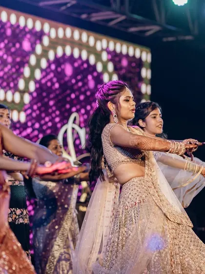 A synchronized moment from the bridesmaids' dance, showing their perfect coordination and stage presence.