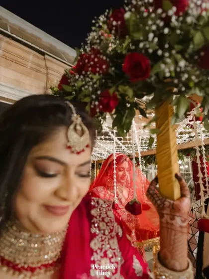 A creative shot of the bride's entrance, seen from the perspective of her bridesmaid, adding a personal and intimate touch to the moment.