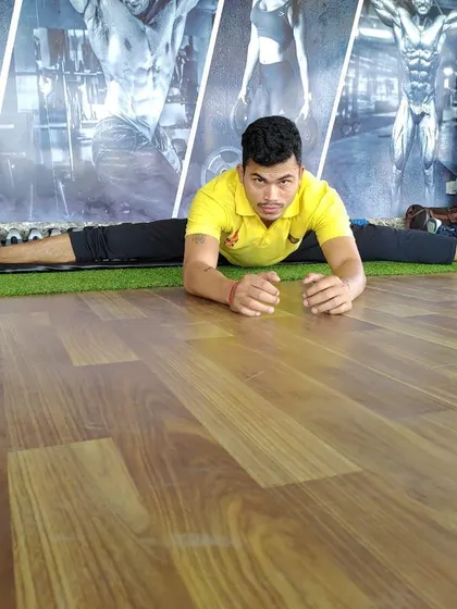 Close-up on the split, showing full engagement. This stretch targets the hamstrings and hip flexors.