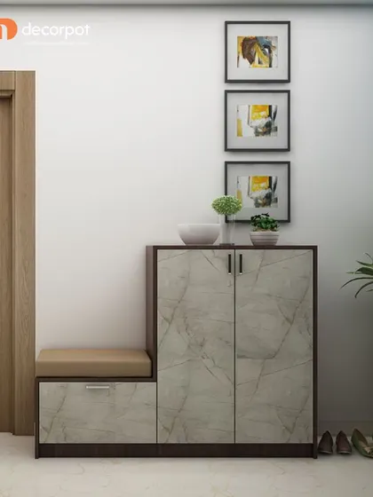 This foyer unit combines a shoe cabinet with a comfortable seating bench. The marble-finish doors and dark wood frame create a modern and elegant look for your home's entrance.