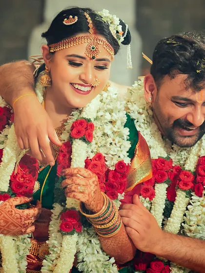 A candid and joyful moment between a couple during their wedding ceremony, sharing a happy embrace.