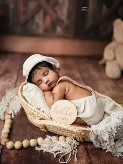 "Hello World!" This little one is posed perfectly in a basket with a cute newsboy cap, creating a timeless and heartwarming announcement photo.