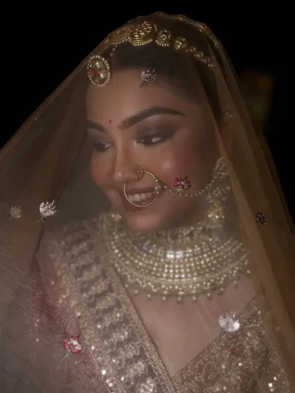 A dreamy shot of the bride under her veil. The soft lighting accentuates the glow on her skin and the sparkle in her eyes.