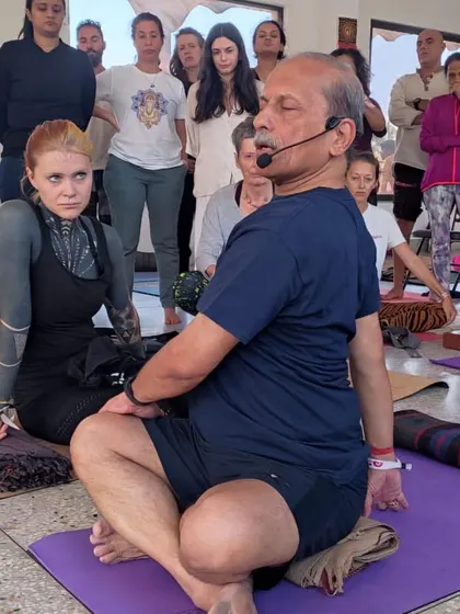 Guiding students through a seated twist. My classes are interactive, with clear instructions and a focus on each individual's practice.
