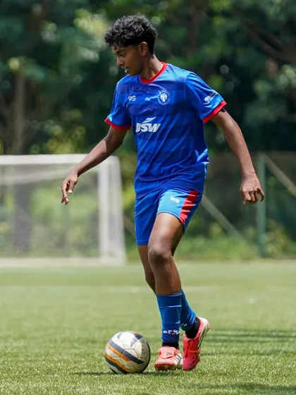 A player dribbles with confidence during a winning match. Our training prepares players to perform under the pressure of competition.
