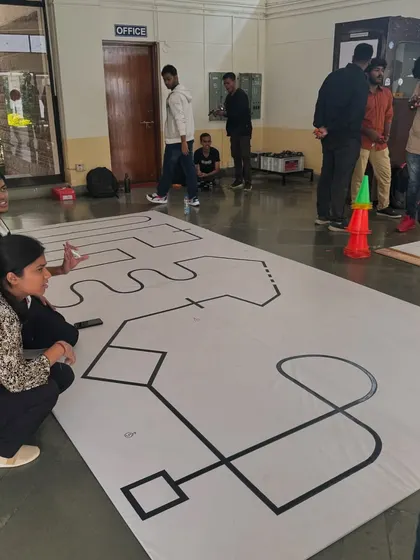 Students at IISc's Pravega tech fest strategize around the line-following course. Events like these are a fantastic platform for students to test their engineering skills in a competitive setting.