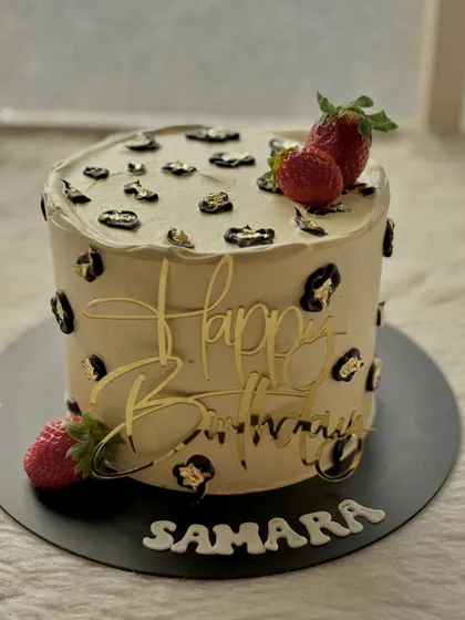 A chic and trendy leopard print cake. I hand-painted the gold and black spots and topped it with fresh strawberries for a pop of color.