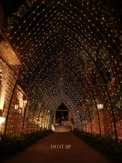 A breathtaking entrance tunnel made entirely of fairy lights. Walking through this feels like stepping into a different world, creating a truly memorable experience for guests.