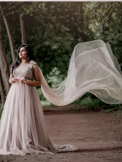 The flowing dupatta of this pastel gown-saree creates a beautiful, ethereal effect. It's a unique rental piece for someone who wants a modern twist on a saree.