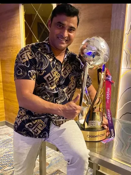 The spoils of victory. Pravin Tambe poses with the LLC T20 championship trophy, a symbol of the hard work and dedication that we aim to cultivate in our students.