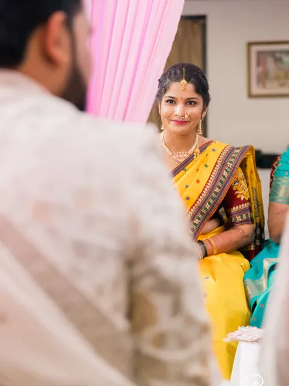 An over-the-shoulder shot of the bride looking at her groom during the ceremony.