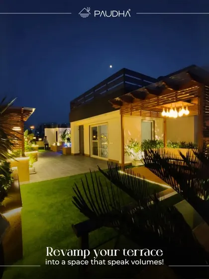 Revamp your terrace into a space that speaks volumes. This stunning night shot shows a multi-level rooftop design with a lawn, a pergola, and beautiful ambient lighting, perfect for a party.