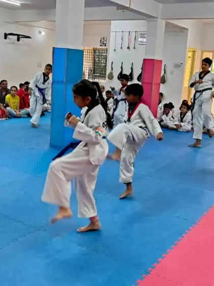 A student executes a jumping kick.