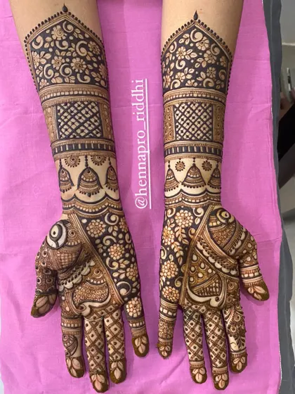A gorgeous three-fourths length design filled with classic floral and geometric patterns. The hanging jhumka motifs add a delicate and feminine touch to the overall design.