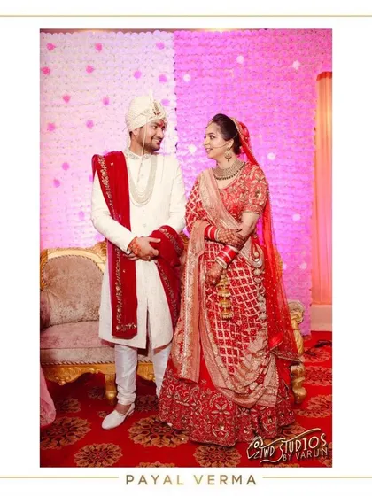 For her special day, this bride chose a classic red lehenga featuring modern dabka embroidery with pearls. We completed her look with two dupattas, and for the groom, we created a custom sherwani dupatta to perfectly coordinate their wedding outfits.