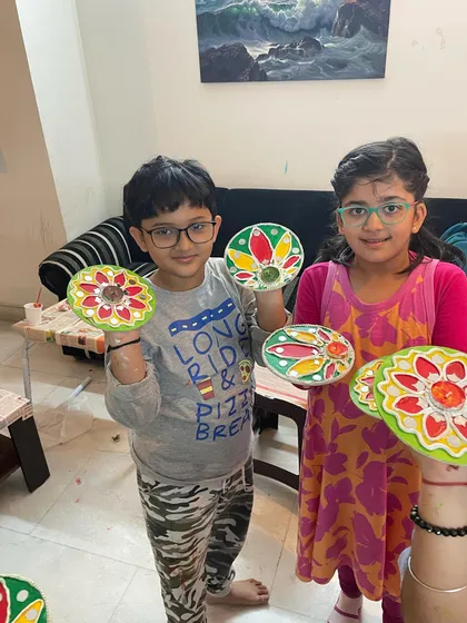 Two proud artists showing off their finished Lippan Art tea light holders from our Diwali workshop. They did such a fantastic job with the bright colors and patterns. I love seeing the pride they take in their work.