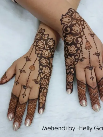 A beautiful Arabic-inspired design with floral vines and hanging bell motifs. The pattern flows diagonally across the hands, creating a graceful and elegant look.