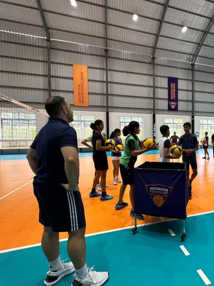 Our players listen as a volleyball coach explains the dynamics of jumping and spiking, which can enhance the power and timing of their jump smash.