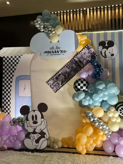 A retro take on the Mickey Mouse theme, using a pastel color palette. The decor features a vintage trailer-style backdrop, a filmstrip detail, and classic Mickey illustrations.