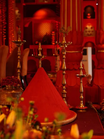 A detail shot of the sindoor mounds and brass diyas. These elements were central to our 'Lal Bagh' theme, symbolizing prosperity, tradition, and the divine energy of Shakti.