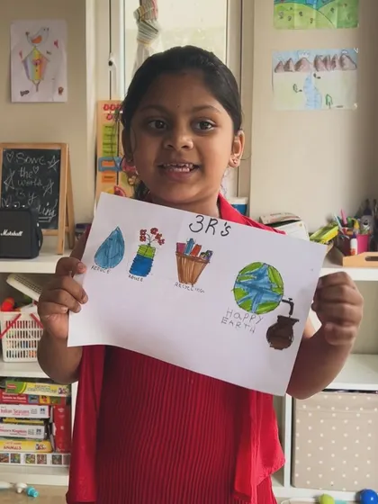 This artist is proudly displaying her drawing about the 3 R's: Reduce, Reuse, Recycle. A great lesson learned through art.