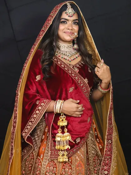 A full view of the magnificent Rajwadi bridal lehenga, complete with a contrasting yellow dupatta. The velvet blouse and intricate skirt embroidery are fit for a queen.