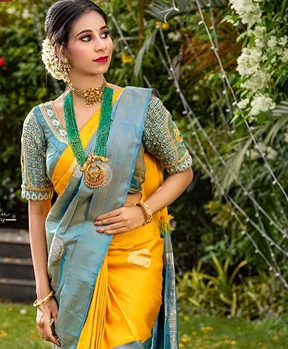 The combination of light blue, yellow, and green in this saree and blouse is fresh and elegant.