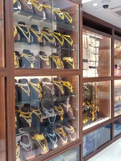 The display cabinets in my store are filled with a dazzling collection of necklaces and fashion accessories, perfect for every style.