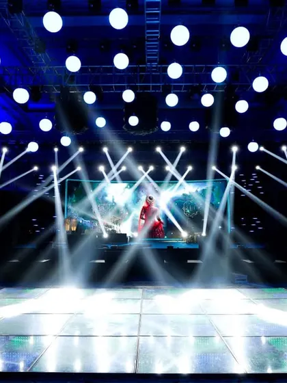 A cosmic-themed sangeet stage with a massive LED screen and a state-of-the-art lighting rig. We create concert-level experiences that transport guests to another world, complete with stunning visuals and effects.