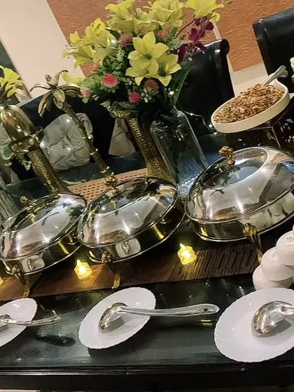A compact setup on a glass dining table for a house party of 30, showing how we can work with any space.
