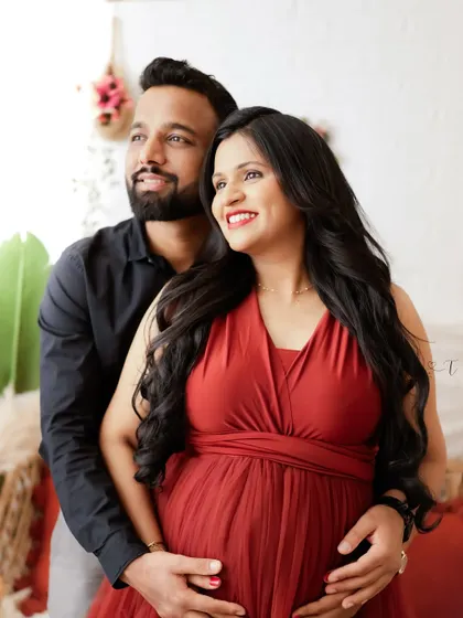 Looking towards the future together. This couple's portrait captures their hopeful and happy expressions as they anticipate the arrival of their baby.