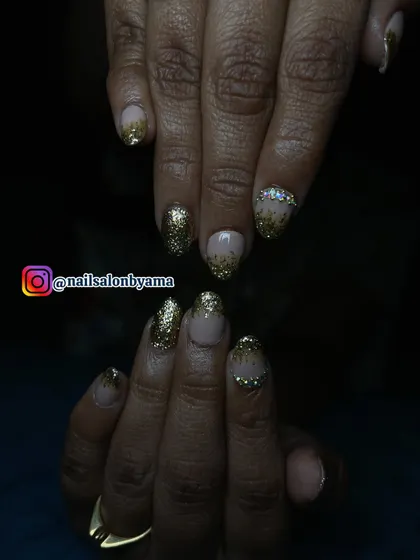 This shot, taken in lower light, shows how the gold glitter and rhinestones catch the light, ensuring your hands look stunning even in the evening.