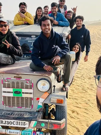 A selfie capturing the fun of a jeep safari in the Thar desert. These moments of shared excitement with your friends are what our trips are all about.