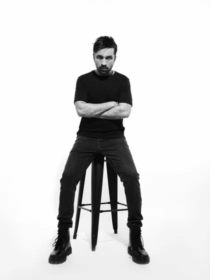 A classic artist portrait. Just me, a stool, and a direct look at the camera.