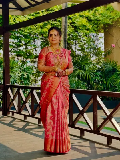 A real bride in a beautiful pink Kanchivaram. The drape is classic and elegant, perfect for her wedding day.