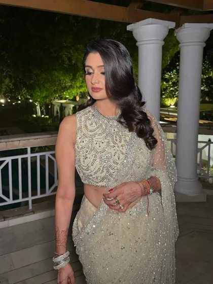 Sparkle and shine! Shefali's reception look is a breathtaking fusion of glamour and grace, with soft smokey eyes and a beautiful berry lip.