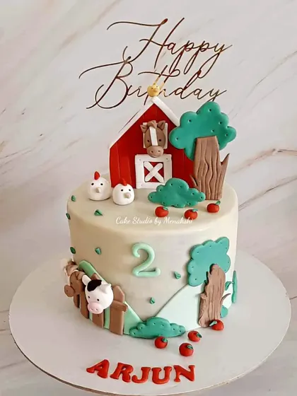 A stunning farm themed cake for a second birthday. Every element, from the red barn to the little chickens, is crafted by hand with love.