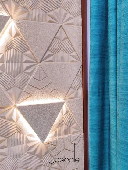 A feature wall with intricate marble engravings becomes a piece of art through the play of light. We use backlighting to highlight the 3D patterns, adding depth and a unique focal point to the living space.
