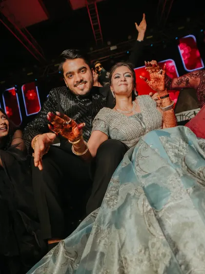 The couple enjoying the Sangeet from a special seating area on the stage, giving them the best view of the performances.