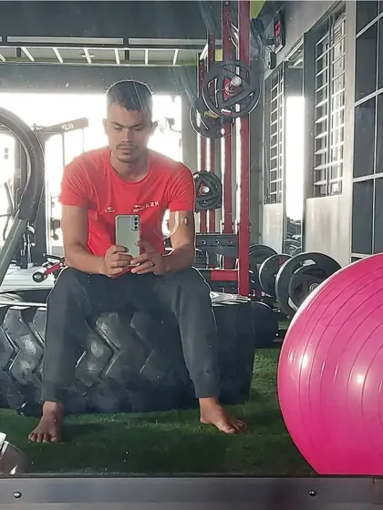 A moment of rest on a tractor tire, part of our functional and CrossFit style equipment. We use varied equipment to challenge your body in new ways.