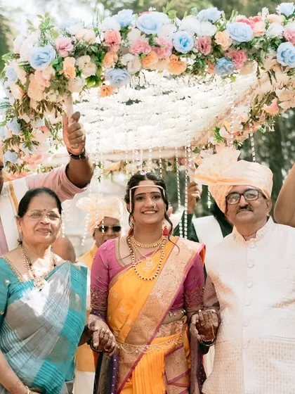 The bride enters with her parents, a proud and emotional moment for the family.