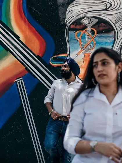 A duplicate of image 6, using vibrant street art as a backdrop adds a splash of color and personality to this urban pre-wedding shoot.