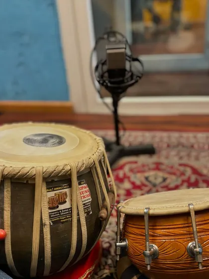 A similar studio setup showing both tabla and dholak. This demonstrates my versatility as a percussionist, able to switch between instruments to best serve the song.