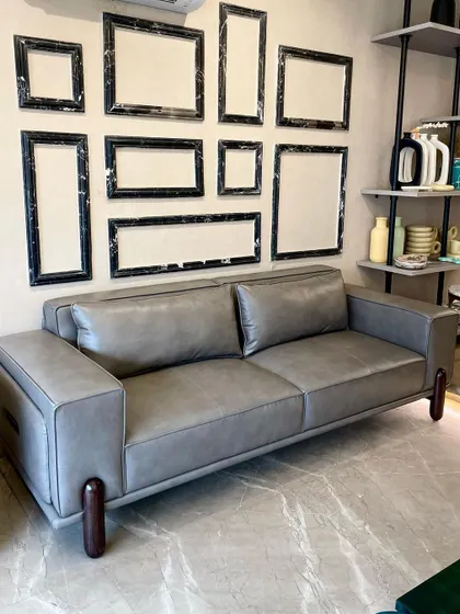 Introducing the 'Academia Sofa'. I designed this with a vintage grey leatherette, bouncy seats, and dark walnut wooden details on the arms and legs for a dark academia vibe. It’s an insanely comfortable sofa perfect for a study or contemporary living room.