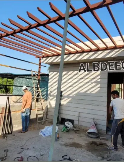This work-in-progress shot from a site in Rohini shows a large pergola frame being installed next to a prefabricated room. You can see the basic structure before the final roofing and finishing touches are applied.
